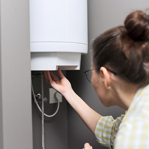 Woman Using Water Heater Woman Using Water Heater